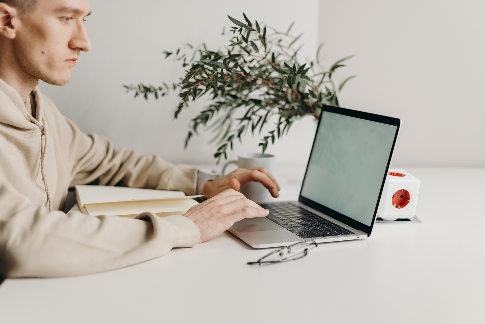 Person in Beige Jacket Using Macbook Pro